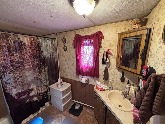 21161 State Highway Ff, Worthington, MO 63567 - bathroom with a textured ceiling, wallpapered walls, vanity, curtained shower, and wainscoting
