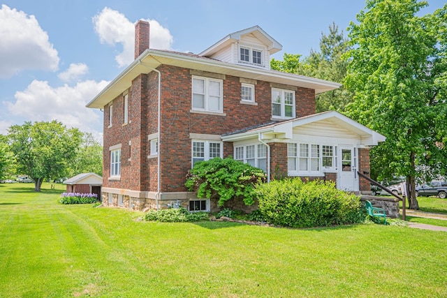 409 E Elm St, Huntsville, MO 65259 - american foursquare style home featuring a chimney, a front yard, and brick siding
