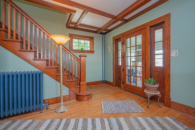 409 E Elm St, Huntsville, MO 65259 - foyer entrance featuring radiator heating unit, coffered ceiling, baseboards, stairs, and wood-type flooring
