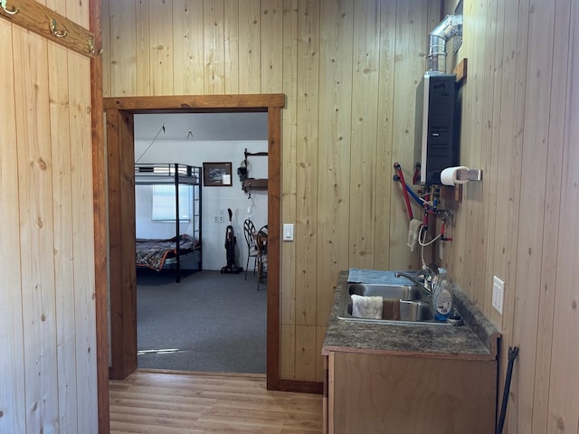 959 Union, Unionville, MO 63565 - hallway featuring wooden walls, water heater, a sink, and light wood finished floors