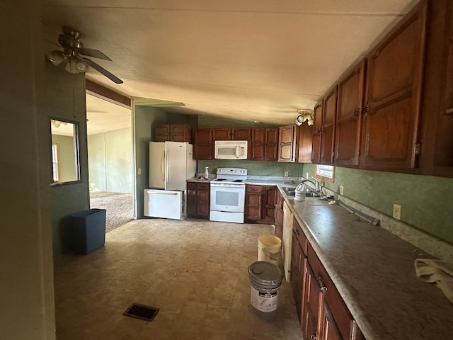 kitchen featuring lofted ceiling, sink, ceiling fan, and white appliances