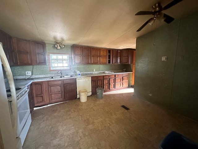 kitchen with decorative backsplash, ceiling fan, sink, and white appliances