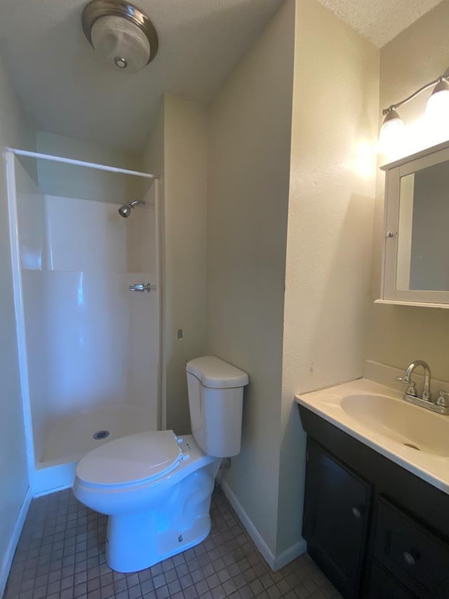 701 E Cottonwood, Kirksville, MO 63501 - bathroom featuring tile patterned flooring, vanity, toilet, and walk in shower