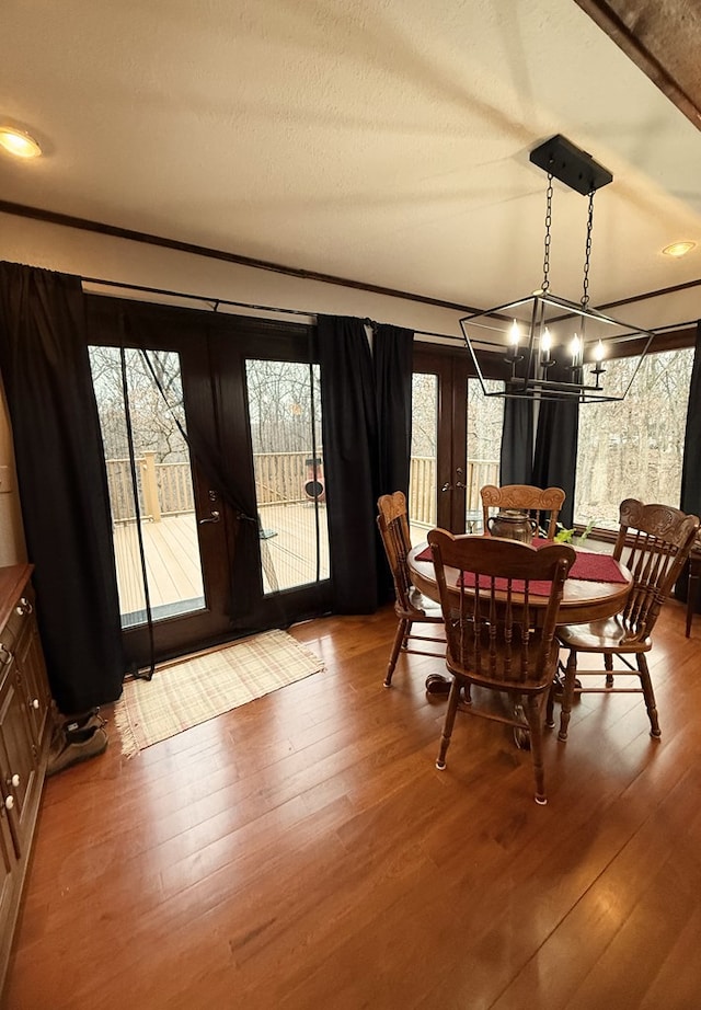 dining space featuring light hardwood / wood-style floors and a notable chandelier