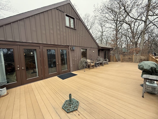 wooden terrace featuring grilling area and french doors