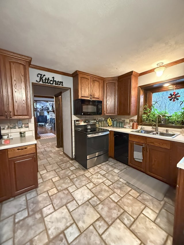 kitchen featuring black appliances, ornamental molding, and sink