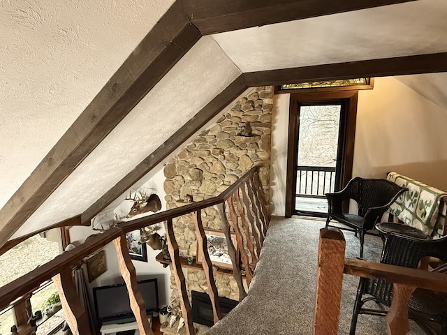 additional living space with vaulted ceiling with beams and carpet floors