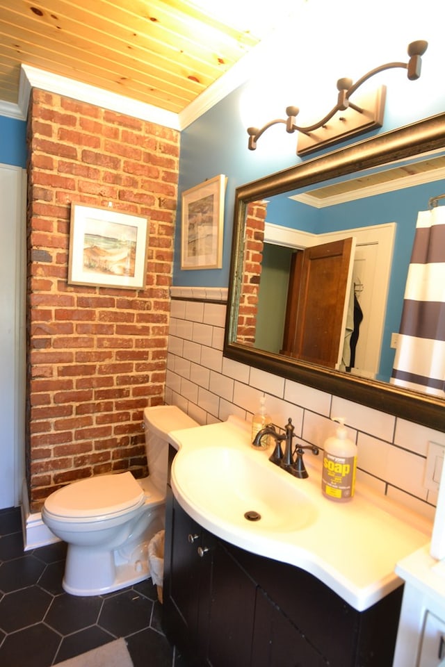 407 E Harrison St, Kirksville, MO 63501 - bathroom with crown molding, vanity, toilet, tile walls, and a wainscoted wall