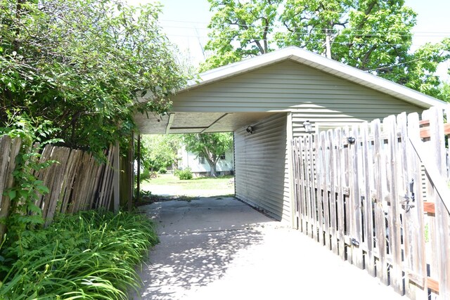 407 E Harrison St, Kirksville, MO 63501 - view of parking featuring a carport and driveway