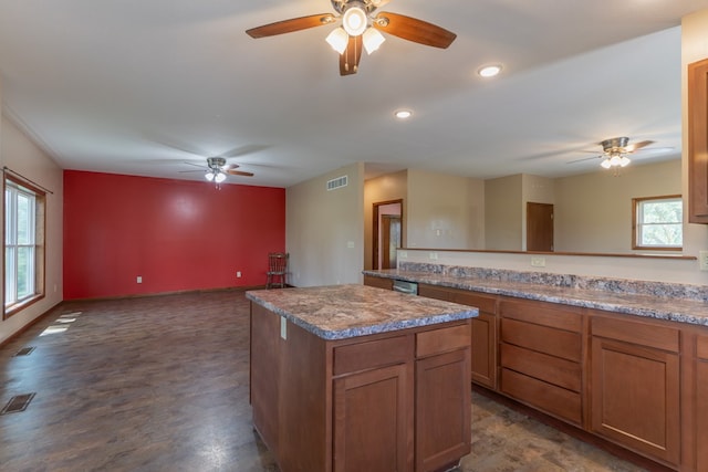 25340 SW Blvd, Bevier, MO 63532 - kitchen with ceiling fan, a kitchen island, brown cabinetry, open floor plan, and recessed lighting