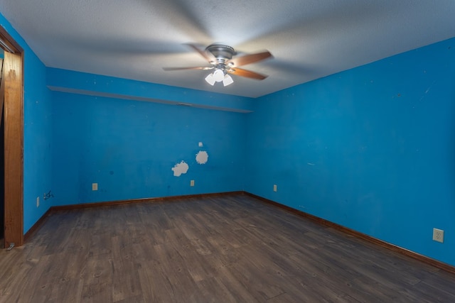 25340 SW Blvd, Bevier, MO 63532 - empty room featuring a ceiling fan and dark wood finished floors