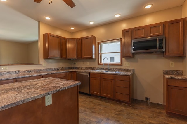 25340 SW Blvd, Bevier, MO 63532 - kitchen with appliances with stainless steel finishes, a ceiling fan, brown cabinetry, dark countertops, and recessed lighting