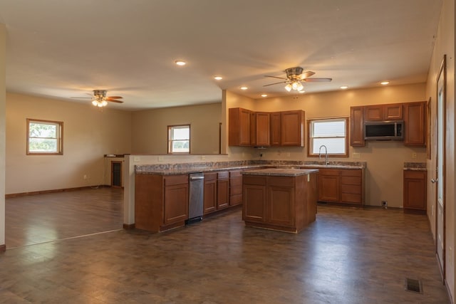 25340 SW Blvd, Bevier, MO 63532 - kitchen featuring a ceiling fan, stainless steel microwave, a peninsula, recessed lighting, and a center island