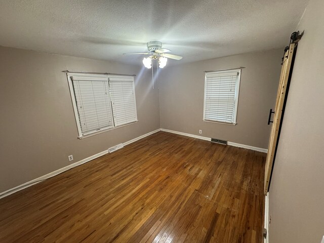 202 W Laharpe St, Kirksville, MO 63501 - empty room featuring wood-type flooring, a textured ceiling, and ceiling fan