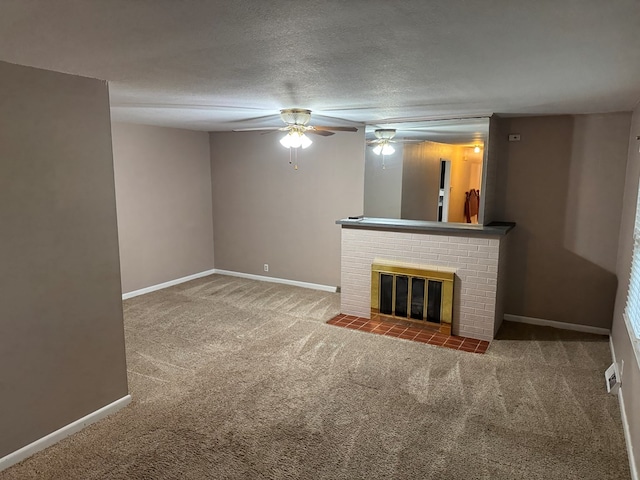 202 W Laharpe St, Kirksville, MO 63501 - unfurnished living room featuring carpet floors, a fireplace, a ceiling fan, and a textured ceiling