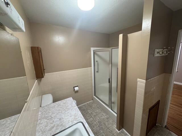 202 W Laharpe St, Kirksville, MO 63501 - full bath with tile walls, a stall shower, a wainscoted wall, an AC wall unit, and vanity