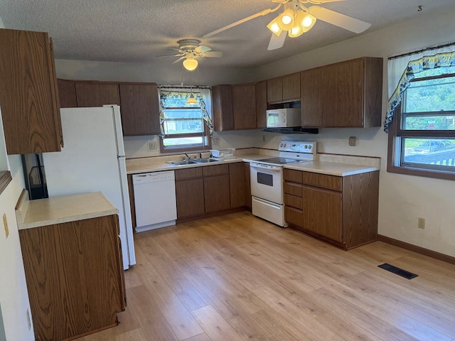 1214 E Washington, Kirksville, MO 63501 - kitchen with white appliances, light countertops, light wood-type flooring, ceiling fan, and a textured ceiling