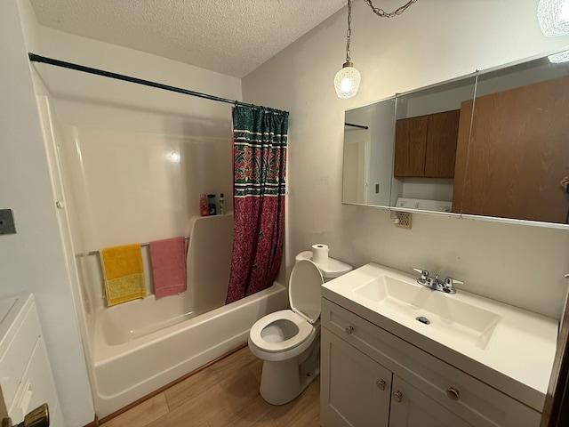 1214 E Washington, Kirksville, MO 63501 - bathroom featuring vanity, wood finished floors, a textured ceiling, and shower / bath combo with shower curtain