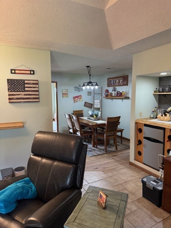 34829 State Highway C, Bevier, MO 63532 - living room featuring vaulted ceiling and a textured ceiling
