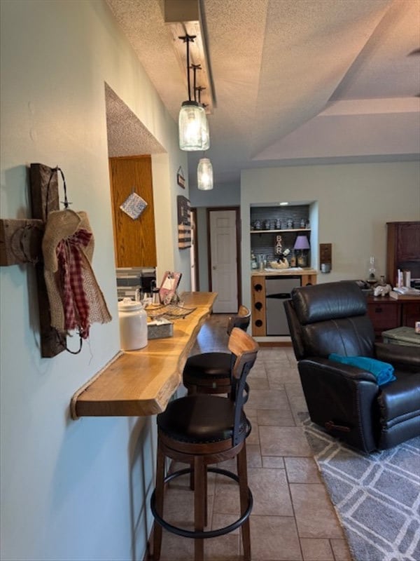 34829 State Highway C, Bevier, MO 63532 - dining area with a textured ceiling and stone finish flooring