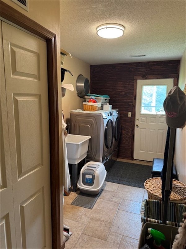 34829 State Highway C, Bevier, MO 63532 - laundry area with washing machine and dryer, a textured ceiling, and stone finish flooring