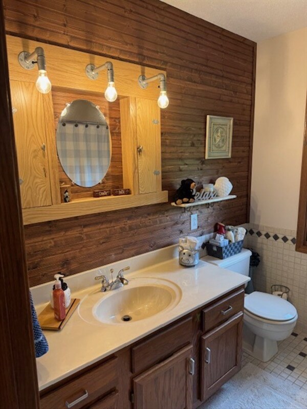 34829 State Highway C, Bevier, MO 63532 - full bathroom featuring vanity, wainscoting, tile walls, and wooden walls