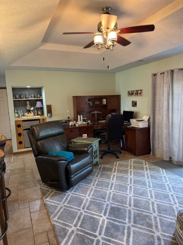 34829 State Highway C, Bevier, MO 63532 - office space featuring a tray ceiling, ceiling fan, a textured ceiling, and stone finish floors