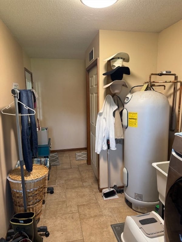 34829 State Highway C, Bevier, MO 63532 - washroom with electric water heater and a textured ceiling