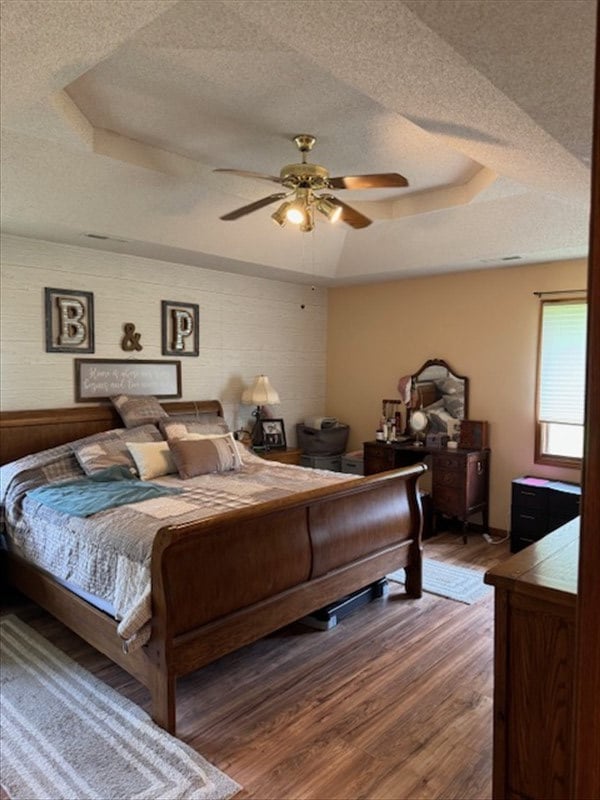 34829 State Highway C, Bevier, MO 63532 - bedroom featuring a raised ceiling, a textured ceiling, wood finished floors, and a ceiling fan