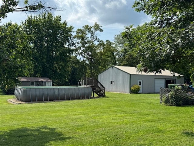 34829 State Highway C, Bevier, MO 63532 - view of green lawn with a detached garage, an outbuilding, an outdoor pool, and stairs