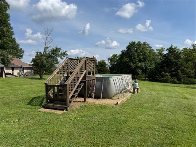 34829 State Highway C, Bevier, MO 63532 - back of house featuring a yard, an outdoor pool, and stairs