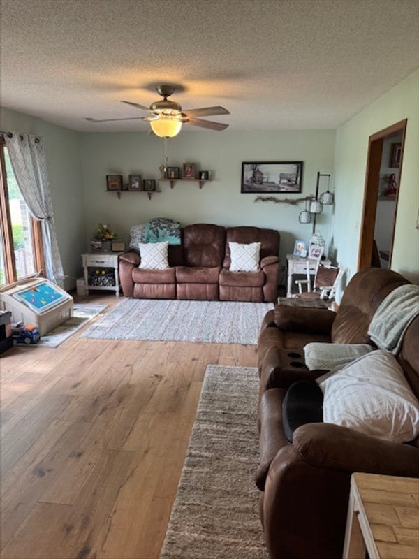 34829 State Highway C, Bevier, MO 63532 - living room featuring a textured ceiling, wood-type flooring, and a ceiling fan