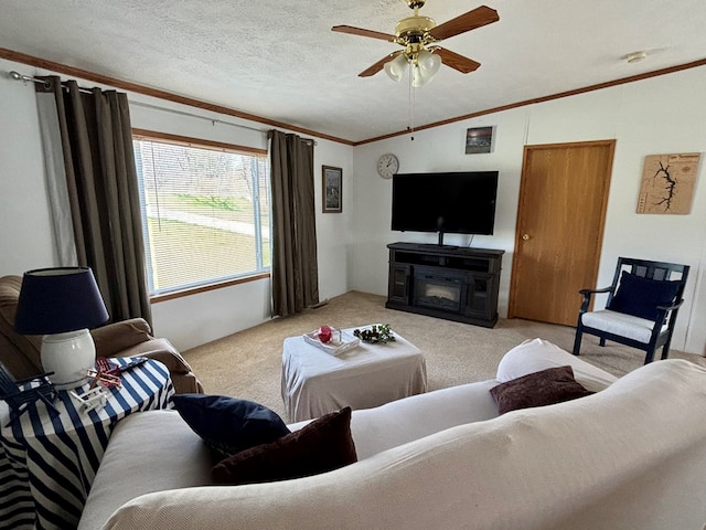 living room with ornamental molding, a ceiling fan, light colored carpet, a glass covered fireplace, and lofted ceiling