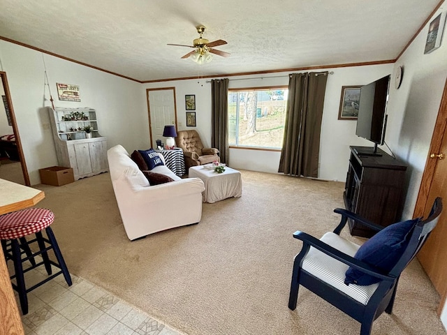 living area with crown molding, ceiling fan, light carpet, and a textured ceiling