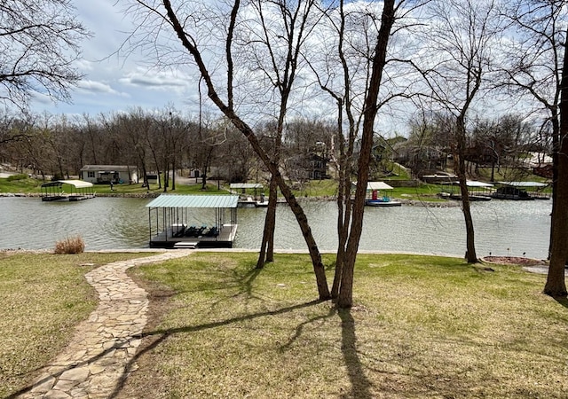 exterior space with a water view and a lawn