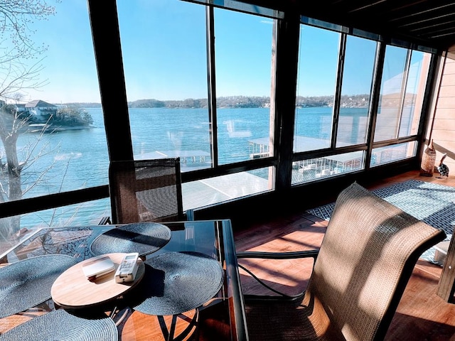 sunroom / solarium featuring a water view