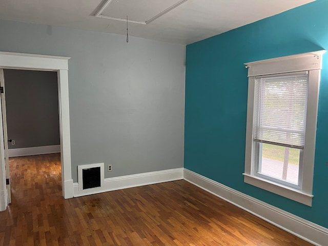 spare room with dark hardwood / wood-style floors