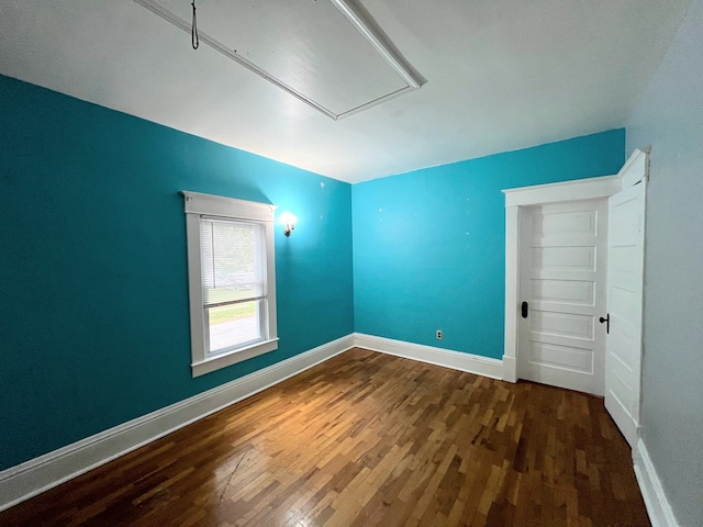 spare room with dark hardwood / wood-style floors