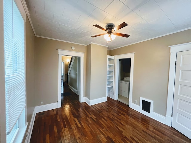 unfurnished room with dark hardwood / wood-style floors, built in features, crown molding, and washer / clothes dryer