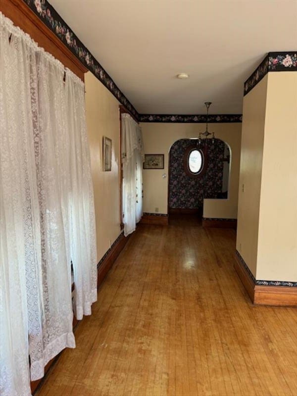 hallway with hardwood / wood-style floors