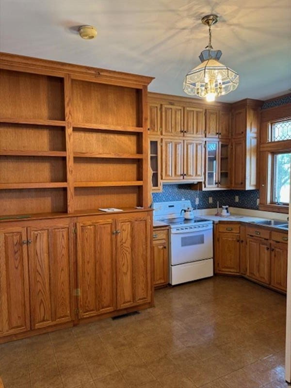 kitchen with backsplash, an inviting chandelier, white range with electric stovetop, sink, and decorative light fixtures