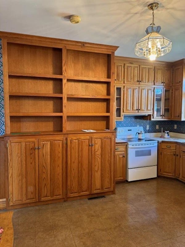 kitchen with tasteful backsplash, hanging light fixtures, and white electric range oven