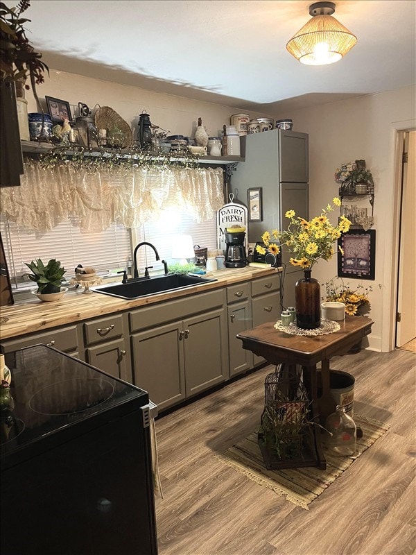 201 N Wentz, Macon, MO 63552 - kitchen with black / electric stove, gray cabinetry, wood finished floors, and open shelves