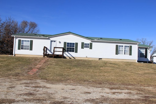 view of front facade featuring a front lawn, crawl space, and metal roof