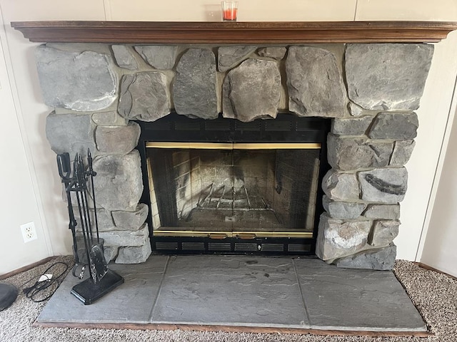 interior details featuring a stone fireplace