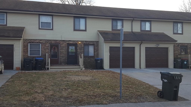 view of property featuring a front lawn and a garage