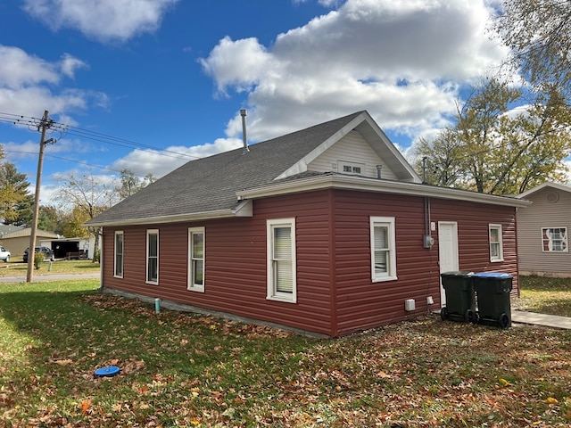 back of property with a lawn