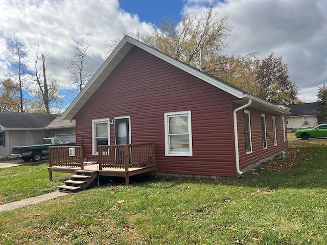 view of side of home featuring a deck and a yard