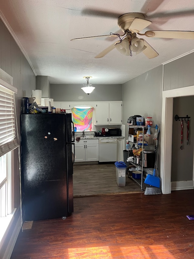 kitchen with white cabinets, white dishwasher, black fridge, and dark wood-type flooring