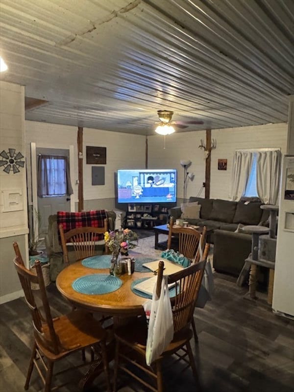 dining area featuring wood ceiling, a ceiling fan, and wood finished floors